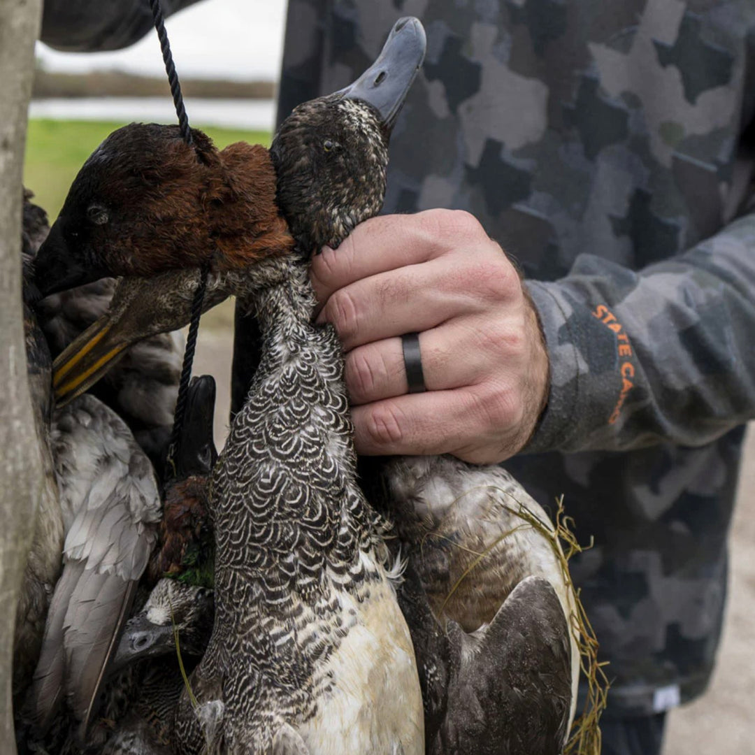 Man wearing Barrel Band while holding duck