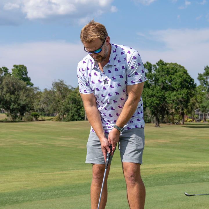 Man playing golf wearing LSU Tiger Camo Gameday Men's performance Polo