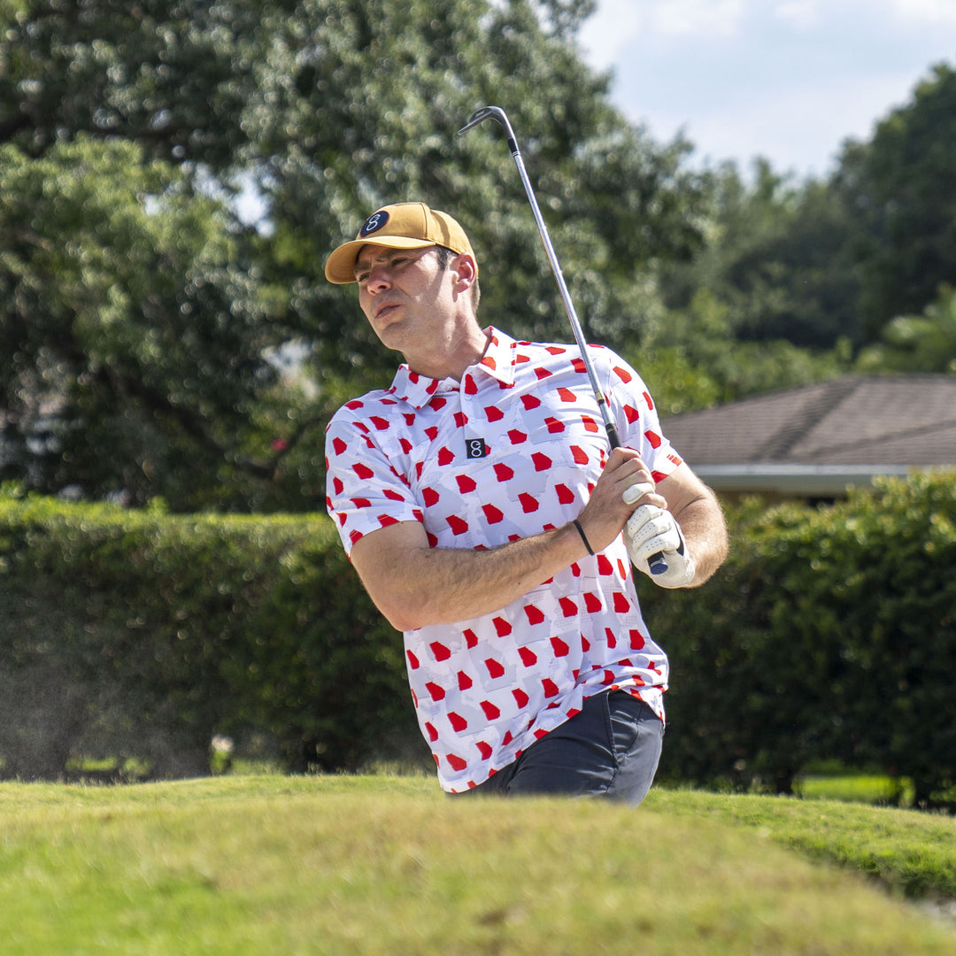 Man playing golf wearing Georgia Bulldog Camo Gameday Men's performance Polo