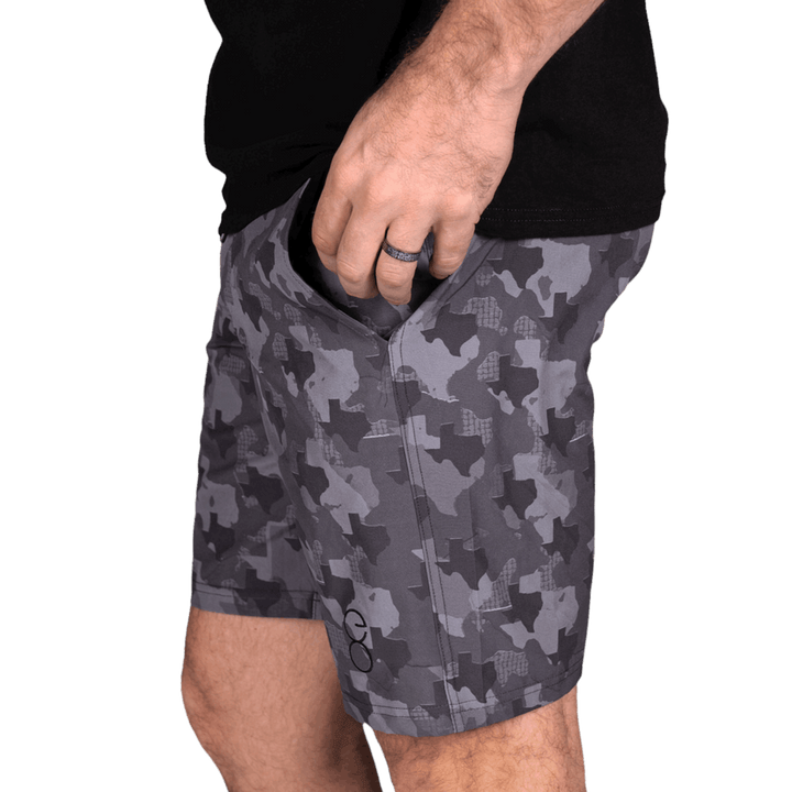 Texas State Camo Everyday Shorts featuring a one-of-a-kind camo pattern made from the outline of Texas.  Designed for versatility, these lightweight men's shorts are perfect for running, swimming, workouts, and everyday wear. A must-have for Texas hunters and outdoor enthusiasts who want to rep their state with pride.