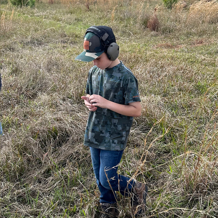 Kid wearing Louisiana State Camo short sleeve shirt